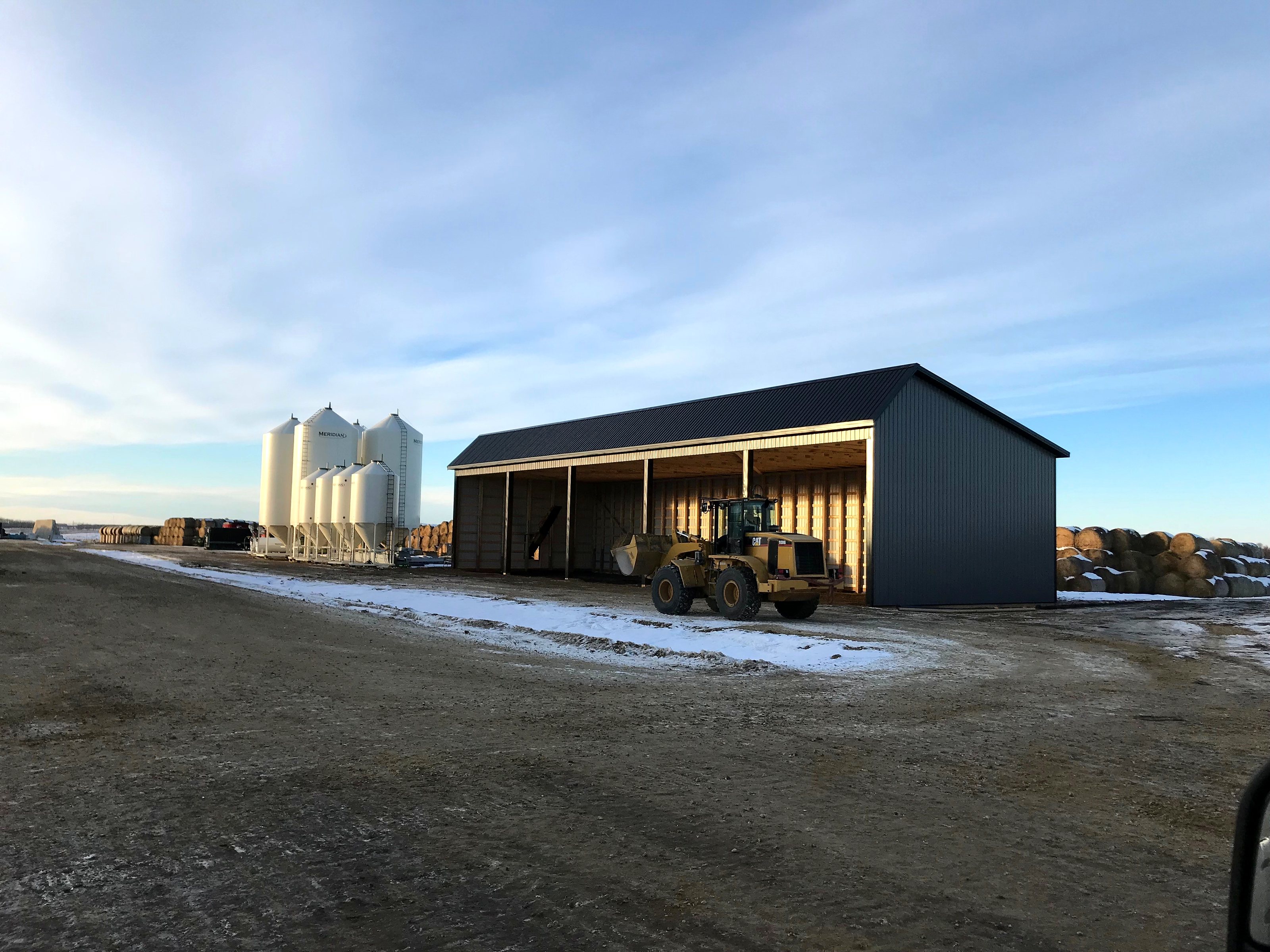The group's John Deere loader under the feed shed at the feedlot