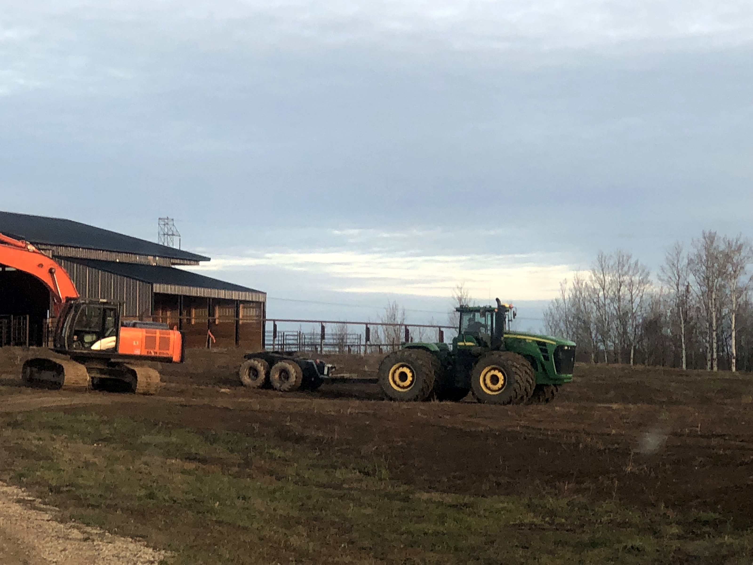 The group's Hitachi excavator and John Deere tractor in the yard in October