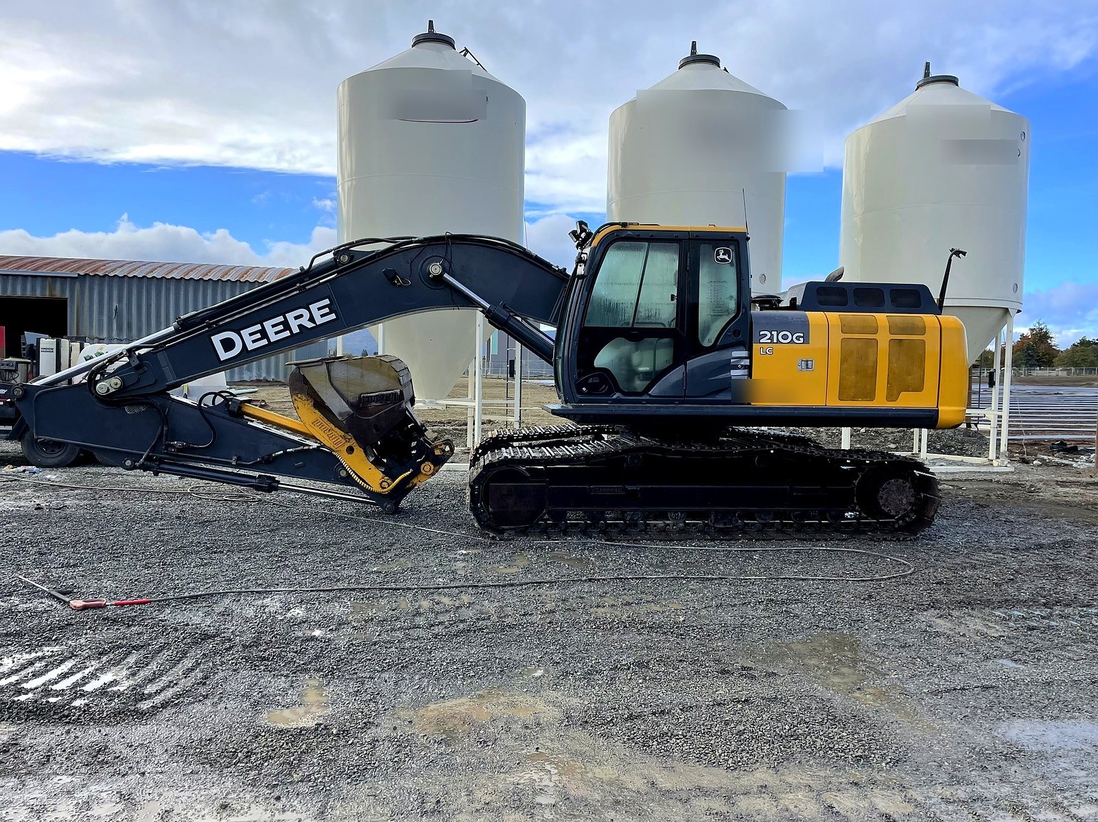 John Deere 210G excavator at the tanks