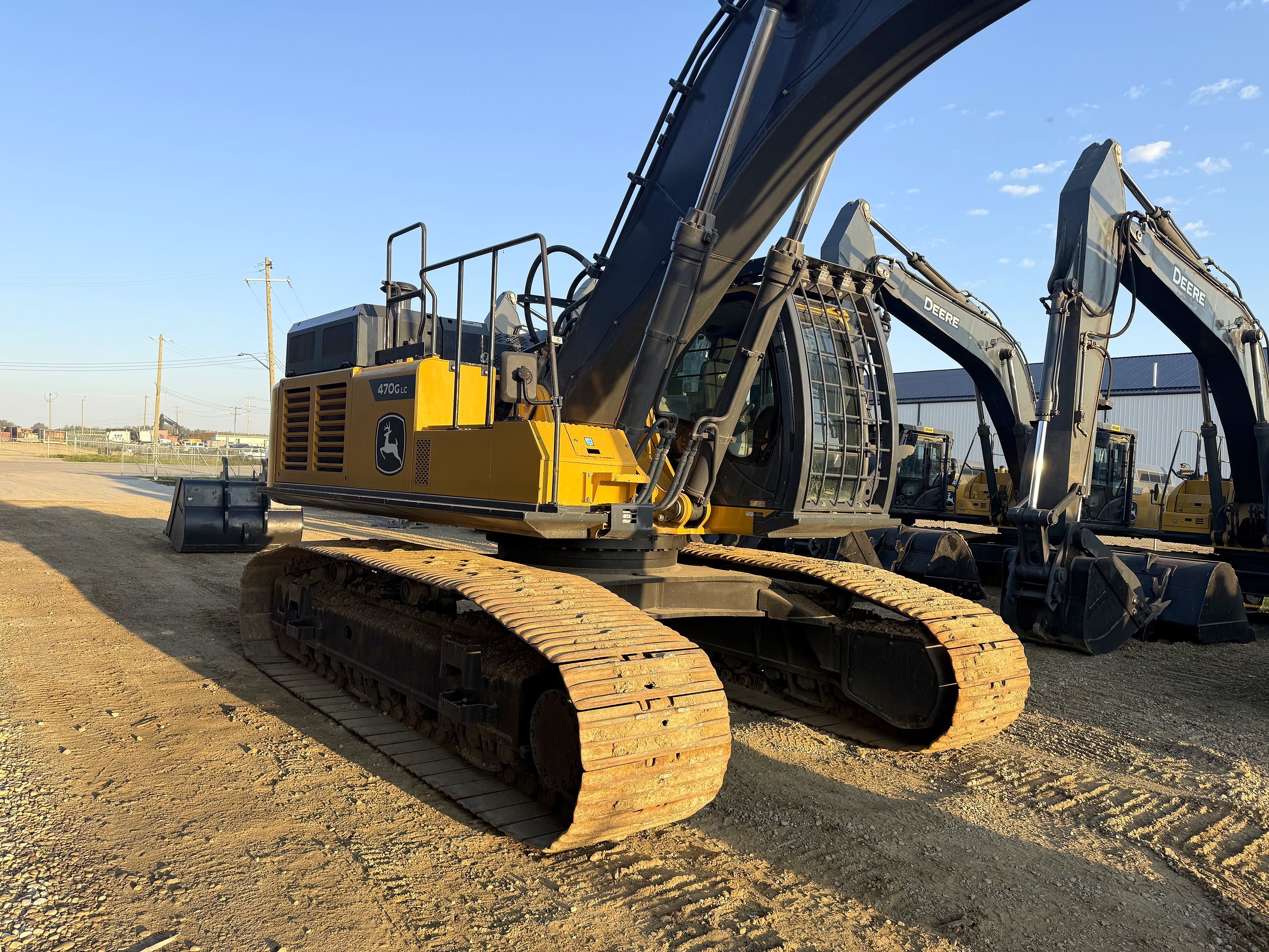 The group's John Deere 470G LC with more excavators lined up behind it