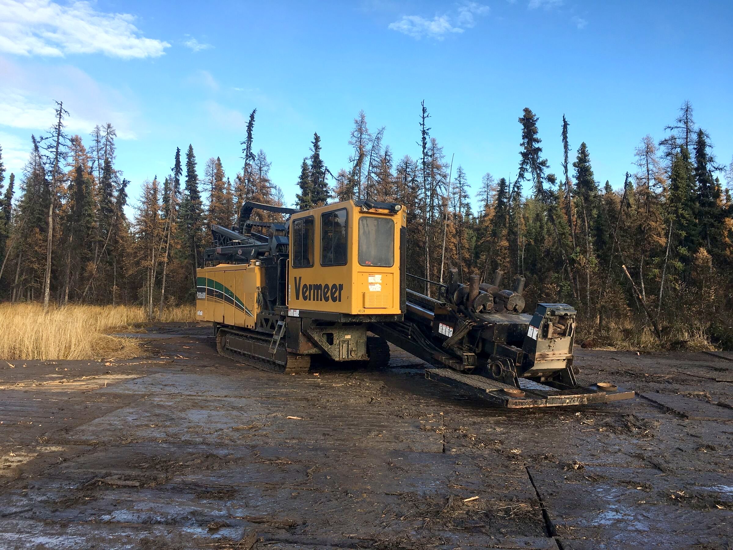 The group's drill rig on mats at golden hour