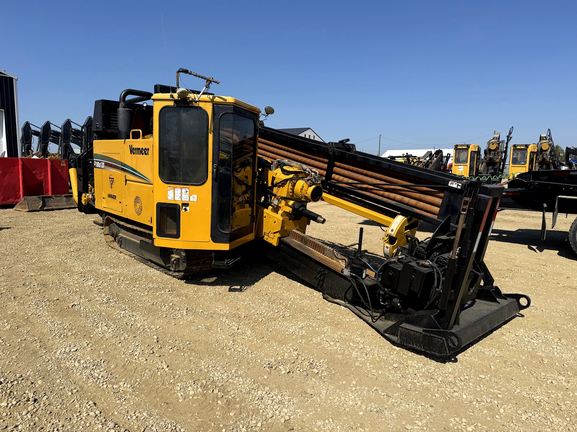 Vermeer D100x120 horizontal directional drill in the yard with a row of rigs staged behind it